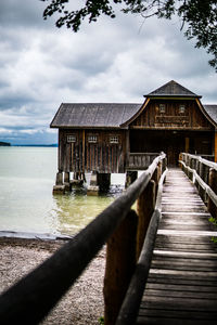 View of building by sea against sky