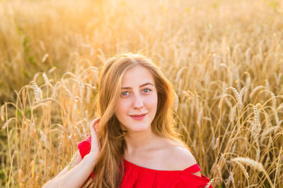 Portrait of beautiful young woman in field