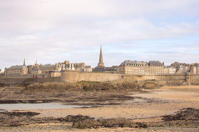 View of the walled city of saint-malo from the sea at low tide, france