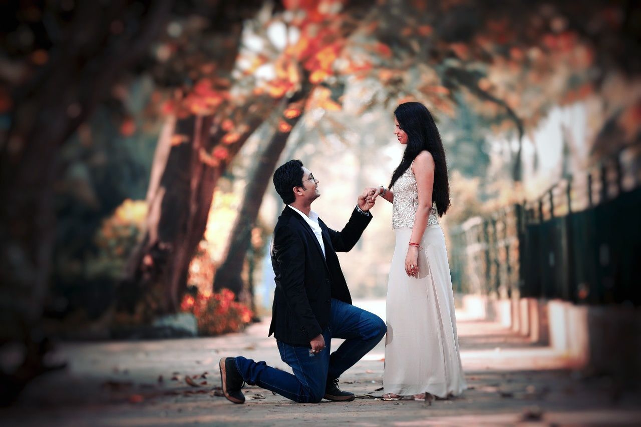 COUPLE HOLDING HANDS WITH UMBRELLA