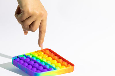 Close-up of person hand holding multi colored background