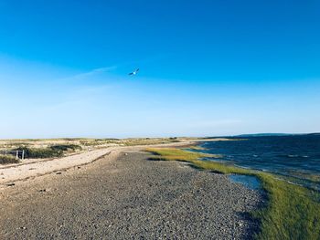 Scenic view of sea against clear blue sky