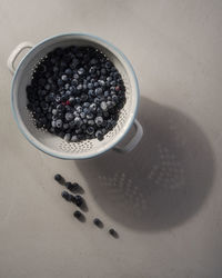 Close-up of blueberries in colander on table