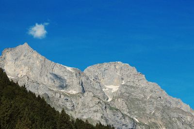 Low angle view of mountain against blue sky