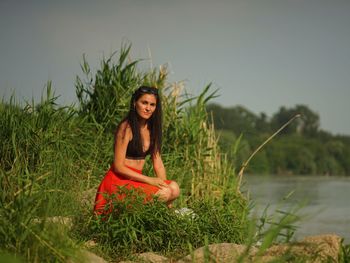 Portrait of smiling woman against plants