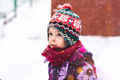 Happy child outdoors in winter on the background of nature. child portrait looking to the side