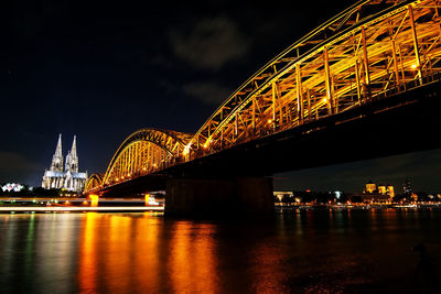 Low angle view of bridge over river at night