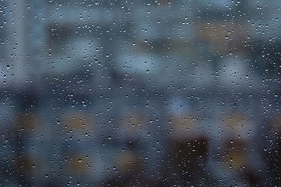 Full frame shot of raindrops on glass window