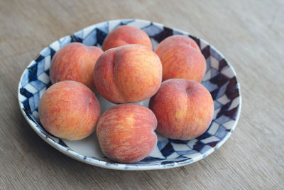 High angle view of apples in plate on table