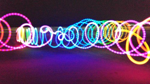 Close-up of light trails over black background