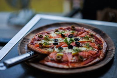 Close-up of pizza served on table