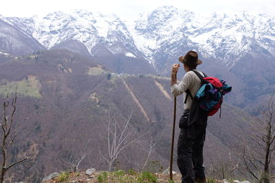 Rear view of man standing on mountain