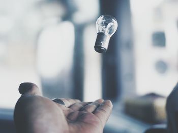 Cropped catching light bulb