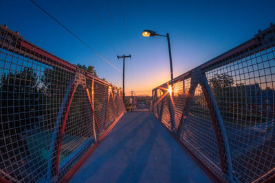 Footbridge against clear sky at dusk