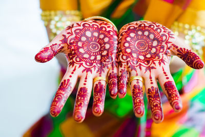 Midsection of bride showing henna tattoo