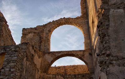 Low angle view of old ruins against sky