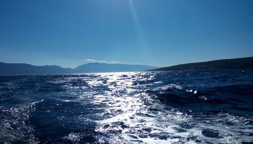 Scenic view of sea against clear blue sky