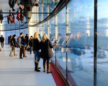 Group of people in front of glass window