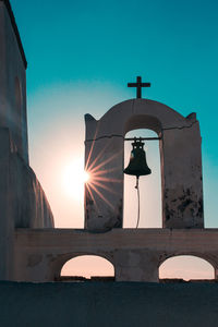 Rear view of woman against building against clear blue sky