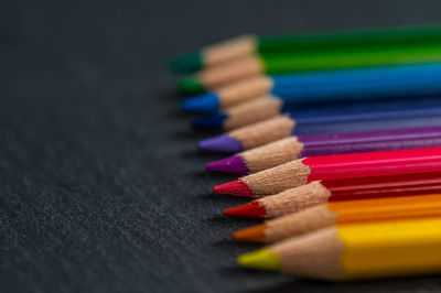 Close-up of multi colored pencils on table