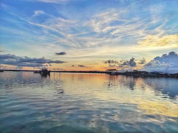 Scenic view of lake against sky during sunset