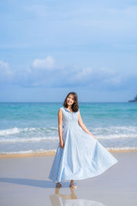 Full length of woman on beach against sky