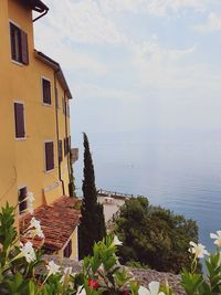 Scenic view of sea and buildings against sky