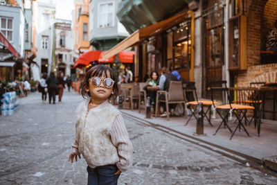 Portrait of young woman in city