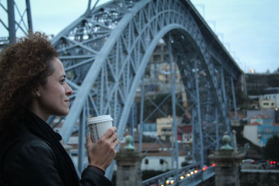 Close-up of woman drinking coffee in city