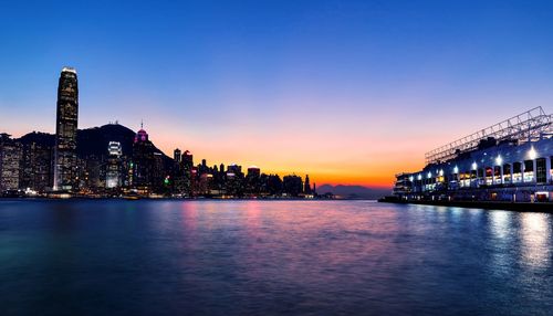 Illuminated buildings in city at waterfront