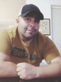 Portrait of young man sitting in hat