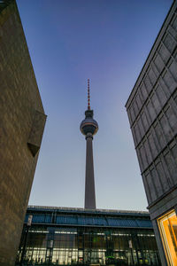 Low angle view of communication tower against clear sky during sunset