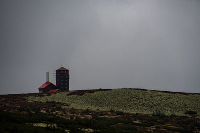 Mountain shelter on the hill against cloudy sky