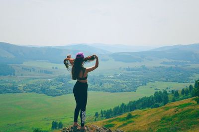 Full length of man standing on mountain against sky