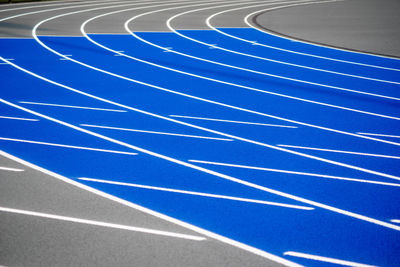 Full frame shot of blue sports track with crisp lines