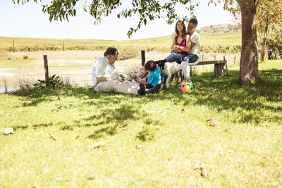 Extended family relaxing on meadow