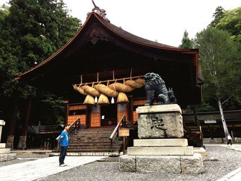 Woman standing in front of temple