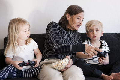 Grandmother with grandchildren playing video games