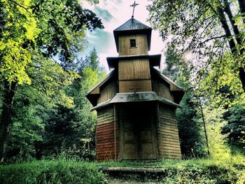 Low angle view of built structure against trees