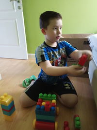 Boy playing with toy at home