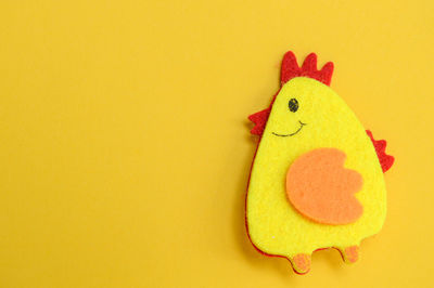 Close-up of stuffed toy against yellow background