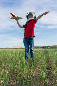 Full length of man standing on field against sky