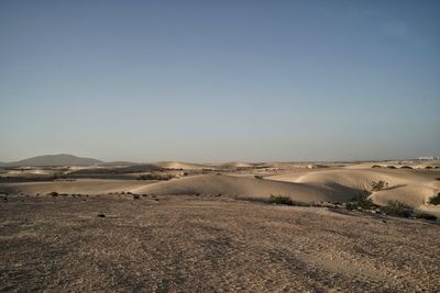 Scenic view of desert against clear sky