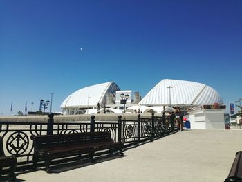 View of buildings against clear blue sky