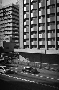 Cars on road against buildings in city
