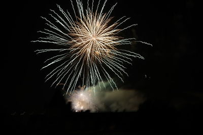 Low angle view of firework display at night