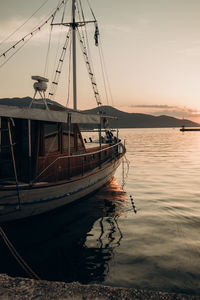 Boats in sea against sky during sunset