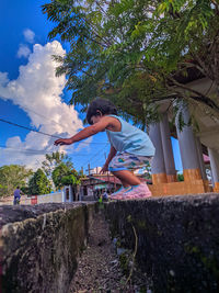 Side view of girl against plants