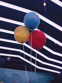Low angle view of balloons against wall