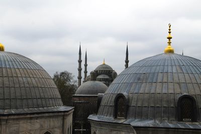 High section of mosques against cloudy sky